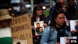 Протестиращи на кръстовището на бул. "Сливница" и ул. "Русе" в София държат снимките на загиналите на 8 май младежи.