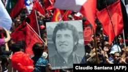 Чилийци на шествие в памет на Виктор Хара, убит дни след военния преврат на Аугусто Пиночет. През декември 2009 г. останките на Хара са официално погребани 36 години след смъртта му, открити и ексхумирани след разследване.