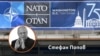 Стефан Попов на фона на логото от срещата на върха на НАТО във Вашингтон, юли 2024 г.