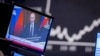 GERMANY – Russia's President Vladimir Putin appears on a television screen at the stock market in Frankfurt, Germany, February 25, 2022