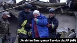 Спасители евакуират възрастна жена от разрушената ѝ къща след въздушното нападение на Русия в Хмелницка област, Украйна, неделя, 25 май 2025 г.
