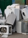 Old electrical appliances in container of recycling center.